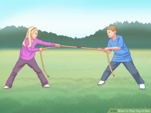 A girl on the left and a boy on the right play tug of war with a rope.